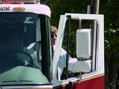 Andrew in dress uniform leaning from the cab of Cumberland Fire Department's Ladder 7